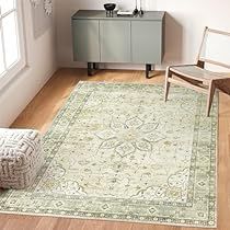 a living room area with a rug, chair and sideboard on the hardwood floor