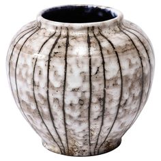 a white and black vase with lines on it