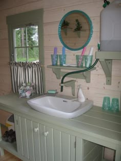 a bathroom sink sitting under a mirror next to a wooden wall with shelves on it