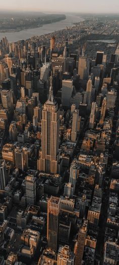 an aerial view of new york city with the empire building in the foreground and other tall buildings