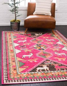 a living room area with a chair, rug and potted plant on the floor