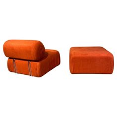 an orange chair and footstool sitting next to each other on a white background