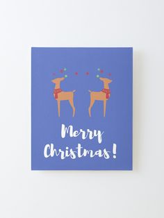 a blue christmas card with two reindeers on it