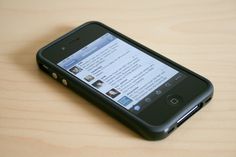 an iphone sitting on top of a wooden table