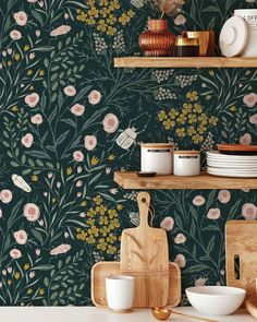 a kitchen with floral wallpaper and wooden utensils on the countertop,