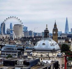 the city skyline is shown with ferris wheel in the background