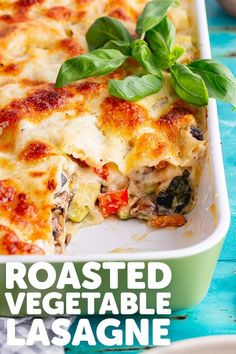 a casserole dish with spinach and cheese in it on a blue table