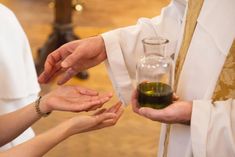 the priest is giving his hands to the woman