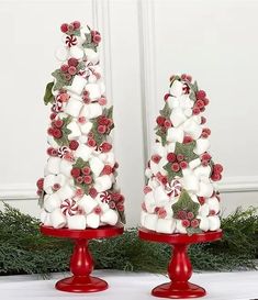 two christmas trees made out of marshmallows and candy