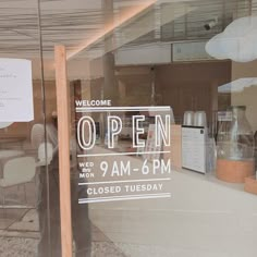 an open sign in the window of a store