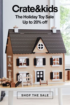 a doll house on a table with the words crate & kids sale up to 20 % off