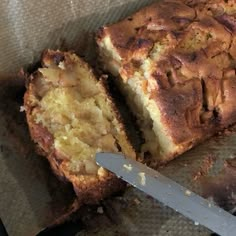 a loaf of bread sitting on top of a table next to a knife