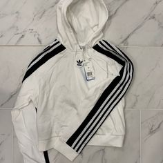 Nwt Women’s Adidas Cropped Hoodie White Winter Sweatshirt With Three Stripes Branding, Winter White Sweatshirt With Three Stripes Branding, White Long Sleeve Sweatshirt With Three Stripes, White Sporty Sweatshirt With Drawstring Hood, White Sporty Sweatshirt With Double-lined Hood, Sporty White Sweatshirt With Drawstring Hood, White Athleisure Hoodie With Double-lined Hood, White Hooded Sweatshirt For Athleisure, White Hooded Sweatshirt Athleisure Style