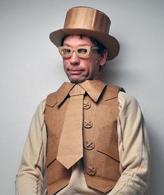 a man wearing a cardboard hat and vest