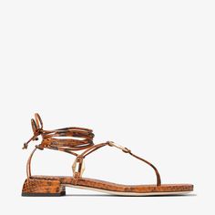 The Onyxia flat sandal is a modern, strappy silhouette crafted from snake print leather. Designed with a flattering wrap-around ankle strap, this style is punctuated by faceted Diamond links in a gold finish. Bridal Boots, Sneaker Dress Shoes, Gold Snake, Silhouette Crafts, Scarf Jewelry, Mens Fragrance, Women Fragrance, Beauty Gift, Printed Leather