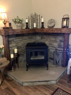 a living room with a fire place in the corner and candles on the fireplace mantel