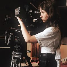 a woman standing in front of a camera