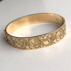 A Vintage bangle displaying beautiful engravings. The wonderful warm yellow gold colour really shows off the detailing perfectly. CONDITION: Great condition. Wear consistent with age and use. Please see photos for more detail. Strong clasp.  BAND WIDTH: 12mm APPROX. INTERNAL MEASUREMENT (AROUND): 180mm DIAMETER (INTERNAL): 53mm x 60mm WEIGHT: 24.1 grams ) Engraved Bangle Bracelet, Custom Bangle, Engraved Bangle, Vintage Bangles, Warm Yellow, Gold Engraving, Gold Colour, Perfect Ring, Pearl Ring