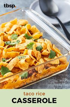 taco rice casserole with cilantro and parsley in a glass dish