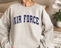 ✈🛫Air Force Unisex Sweatshirt or Hoodie, Air Force College style Sweatshirt, Air Force Army Sweater, Vintage Crewneck, Gift for Air Force Unisex Crew Neck Sweatshirt | Gildan 18000 This well-loved Unisex Crew Neck Sweatshirt is the perfect addition to any collection! The air-jet spun yarn and quarter-turned fabric helps eliminate creases and piling, while the mix of cotton and polyester creates a soft and comfortable feel. 50% cotton, 50% polyester. Unisex Heavy Blend Hoodie | Gildan 18500 With Air Force Sweatshirt, Air Cadets, Air Force Hoodie, Air Force Army, Air Force Gifts, Air Force Shirt, Hoodie Aesthetic, Coffee Sweatshirt, Botanical Shirt