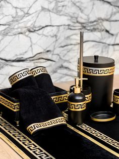 black and gold bathroom accessories on a wooden table