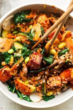 a white bowl filled with vegetables and rice