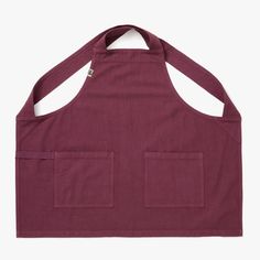 a red apron with two pockets on the front and one pocket at the back that is open