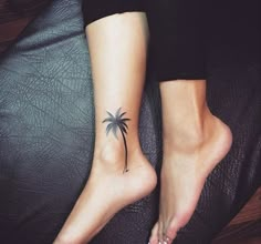 two people with tattoos on their feet and one has a palm tree tattooed on the foot