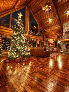 a christmas tree is lit up in the middle of a living room with wood floors