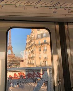 the eiffel tower is seen through an open train window in paris, france