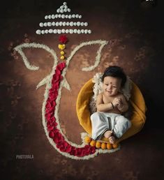 a baby is laying down on a pillow with the word om shanti written in it