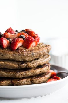 a stack of pancakes with strawberries on top