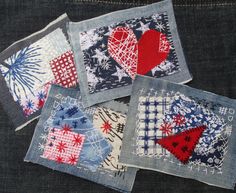 four pieces of fabric with hearts and fireworks on them sitting in the back pocket of a pair of jeans