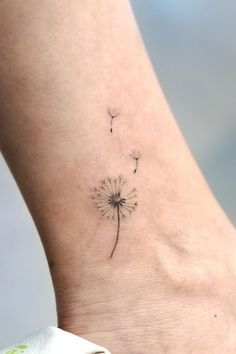 a small dandelion tattoo on the ankle