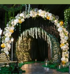 an archway decorated with lights and balloons for a wedding ceremony or reception at night time