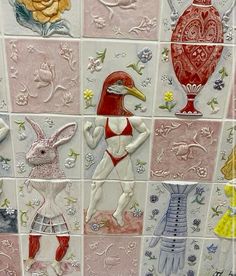 a tiled wall with many different designs on it