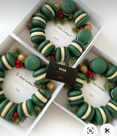 three boxes with green and white decorated cookies in them, one for the holiday season