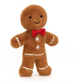 a brown teddy bear with a red bow tie on it's head and chest