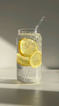 a glass filled with water and lemon slices