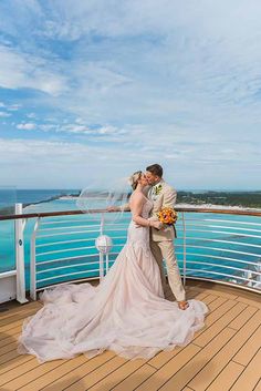 a bride and groom on the deck of a cruise ship