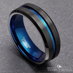 a black and blue ring with an inscription on it