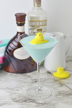 a blue martini with a yellow duck on the rim