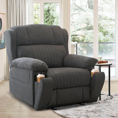 a living room with a gray recliner in it