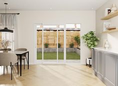 an open living and dining room area with sliding glass doors that lead to the backyard