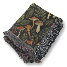 a black and multicolored throw with mushrooms, leaves and plants on it's fringe