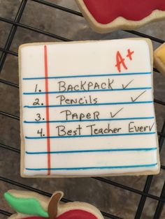 cookies with writing on them sitting on a rack