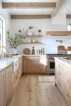 a kitchen with wooden cabinets and white counter tops, along with an open floor plan