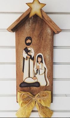 the nativity scene is made out of wood and has a star on top of it