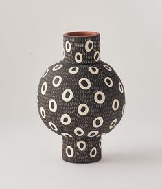 a black and white vase sitting on top of a table