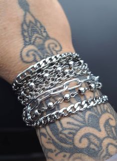 Layered Multi-Strand Steel Bracelet - This punk style or alt goth statement bracelet makes a great gift for her. All stainless steel so this bracelet will NOT tarnish. Completely water proof.  Chains may differ slightly based on stock, but will be same quality, size, and style. ⚡Sizing to help you choose the most accurate size of bracelet. ⚡ Step 1:   Measure your wrist (where you often wear your bracelets) with a tape measure or a long strip of paper, and get your wrist circumference. Step 2:   For a  snug fit, add a 1/2 inch. For a comfort fit, add 1 inch. ⭐RECOMMENDED SIZES:⭐ 7 inch: Extra small frame biological female 7.5 inch: Small frame biological female 8 inch: Medium frame biological female, small frame biological male 8.5 inch: Large frame biological female, medium frame biologic Punk Style Bracelets With Studs, Metalhead Bracelets, Adjustable Stainless Steel Edgy Bracelets, Black Punk Chain Bracelet As A Gift, Black Punk Style Chain Bracelet As Gift, Black Punk Style Chain Bracelet For Gift, Punk Style Black Chain Bracelet Gift, Punk Metal Jewelry With Bracelet Strap, Punk Style Metal Bracelet Strap Jewelry